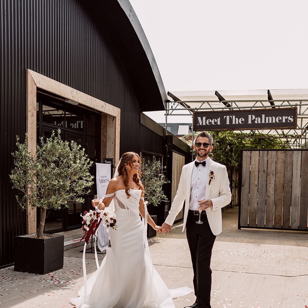 bride-in-corset-wedding-dress-with-groom-in-white-tuxedo