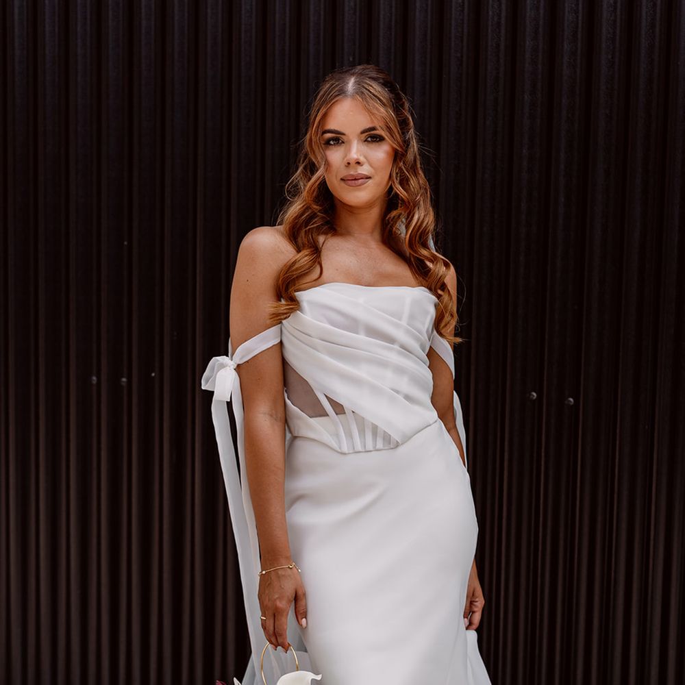 bride-in-corset-wedding-dress-with-pomander-bouquet-orchids