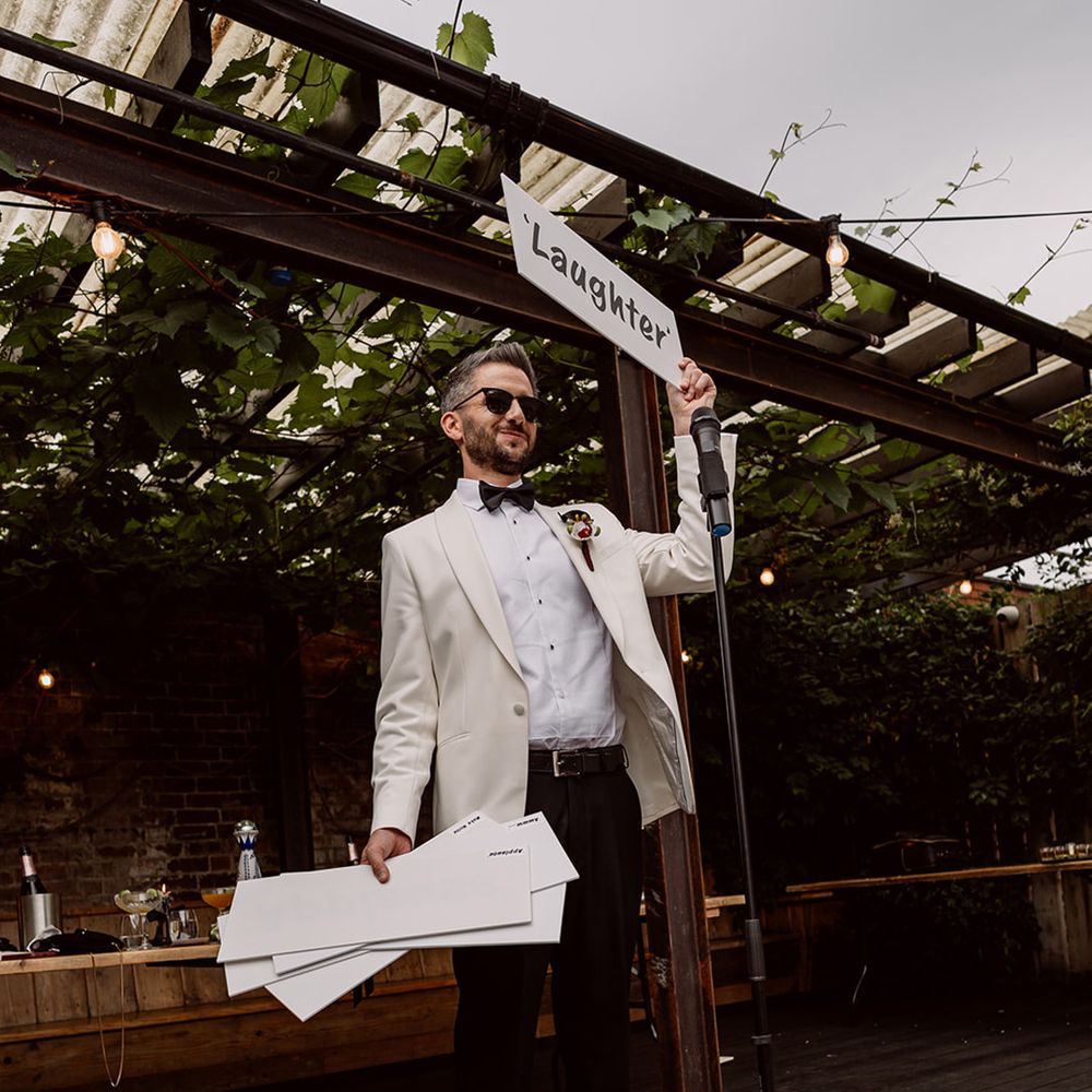 groom-with-funny-crowd-control-signs