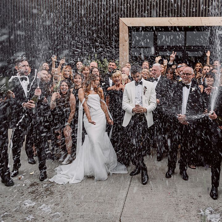 champagne-spray-wedding-party-group-photo