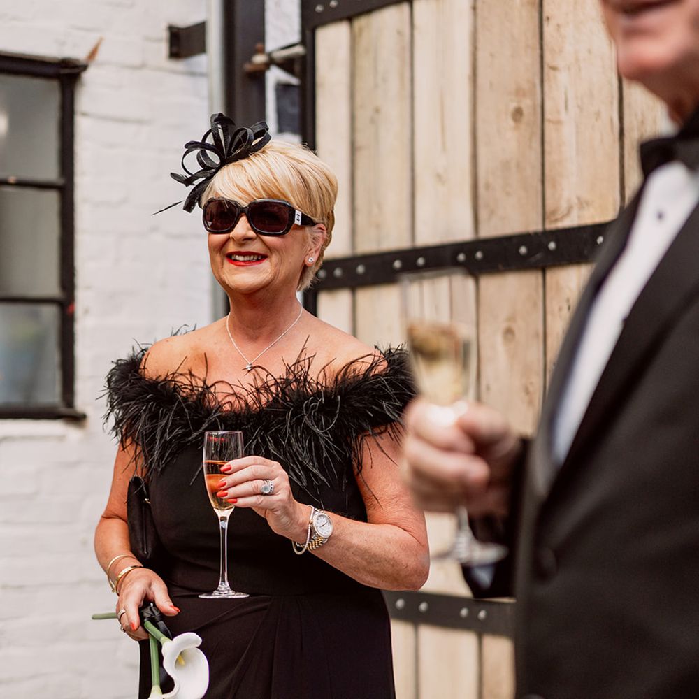 wedding-guest-in-black-feather-dress