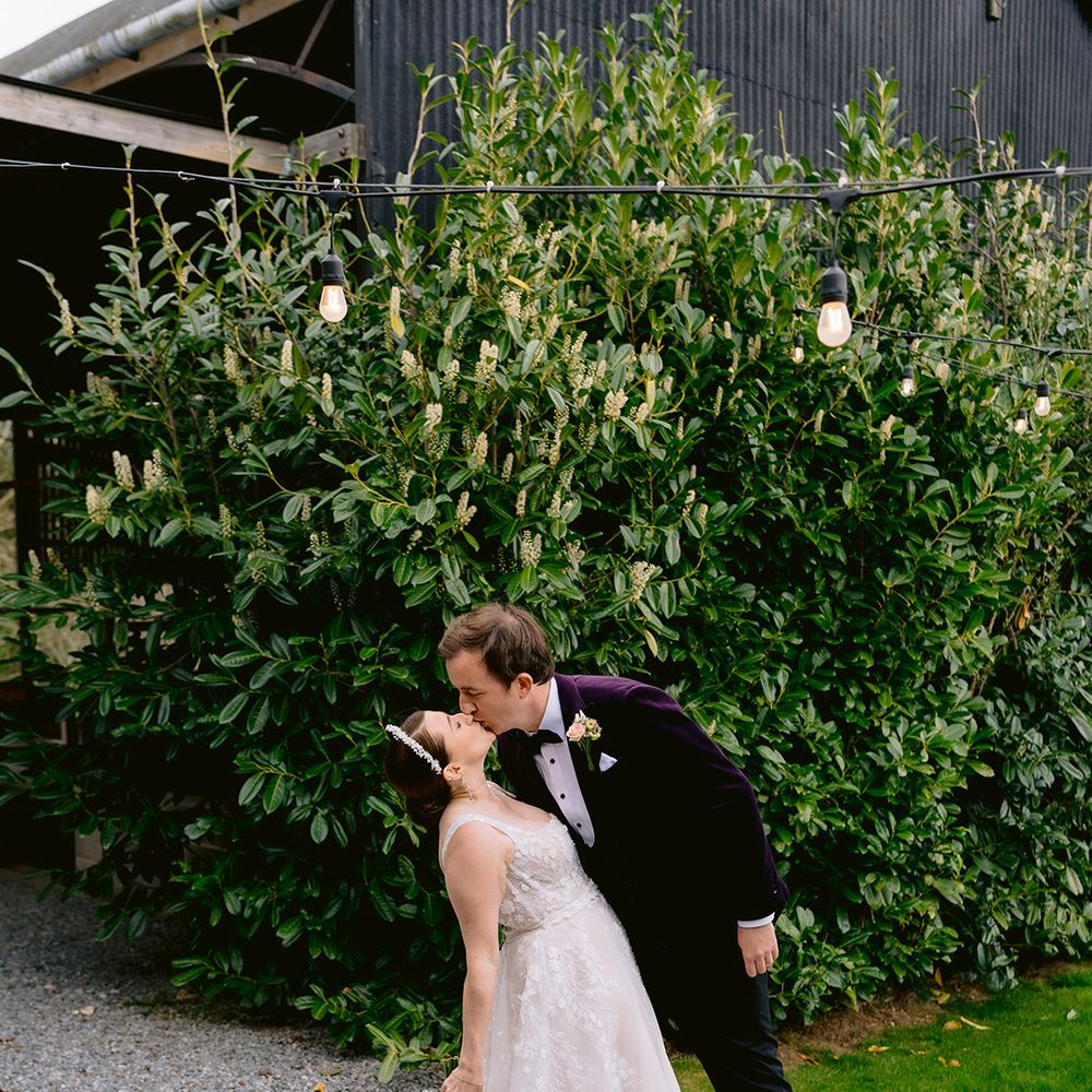 groom-kisses-bride-in-sweet-couple-portrait