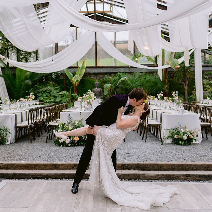 groom-kisses-bride-with-backdrop-of-anran-greenhouse