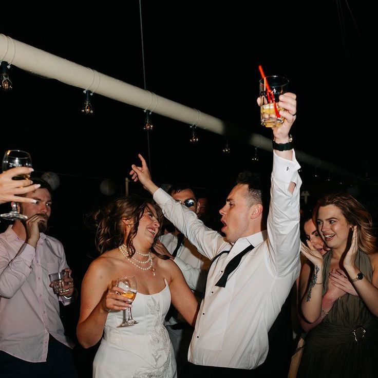 Bride in Short Strapless Wedding Reception Dress Dancing With Groom
