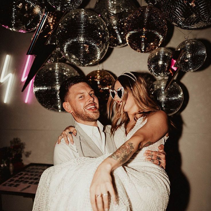 Man lifts fiancee in princess carry at engagement party