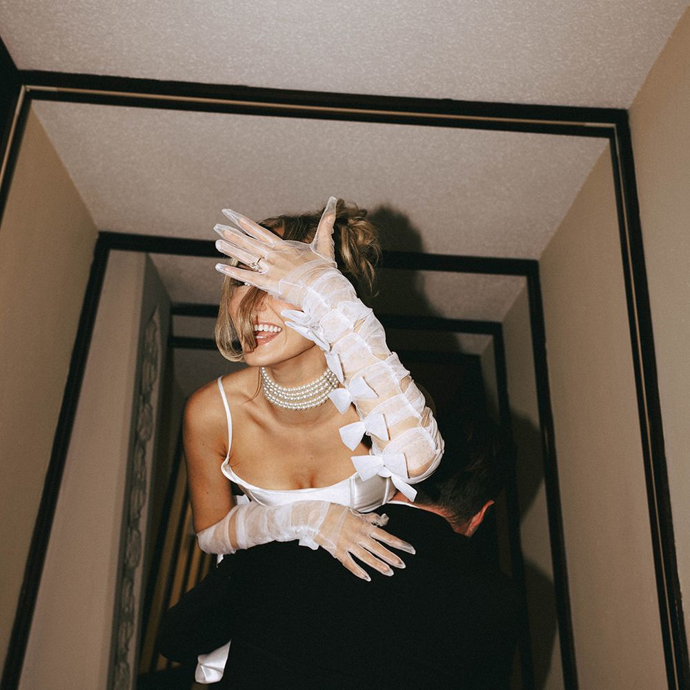 Bride shows off her engagement ring for engagement shoot