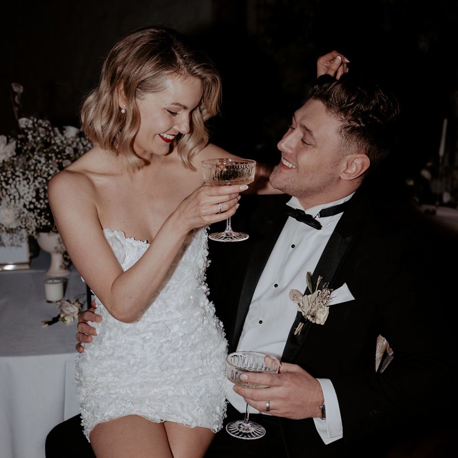 Woman sits on fiancee's lap for engagement party