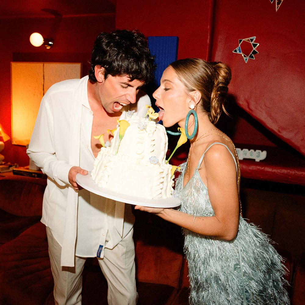 bride-in-blue-tassel-reception-dress-eating-cake-with-groom