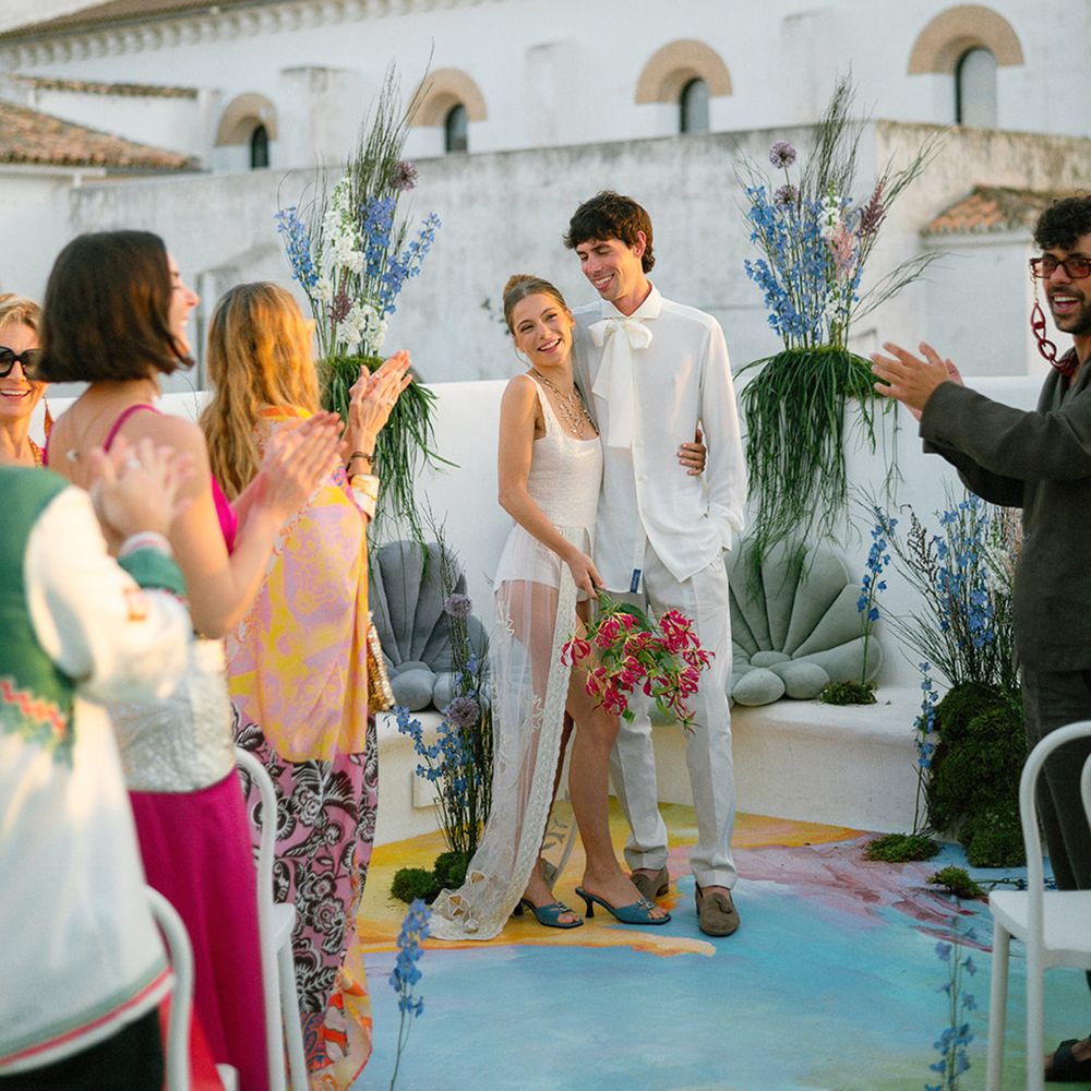 couple-smiles-at-guests-after-wedding-ceremony