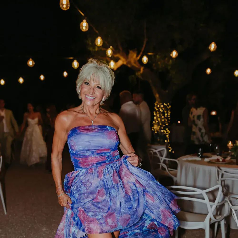 Wedding guest in stylish strapless blue and pink high-low wedding guest dress