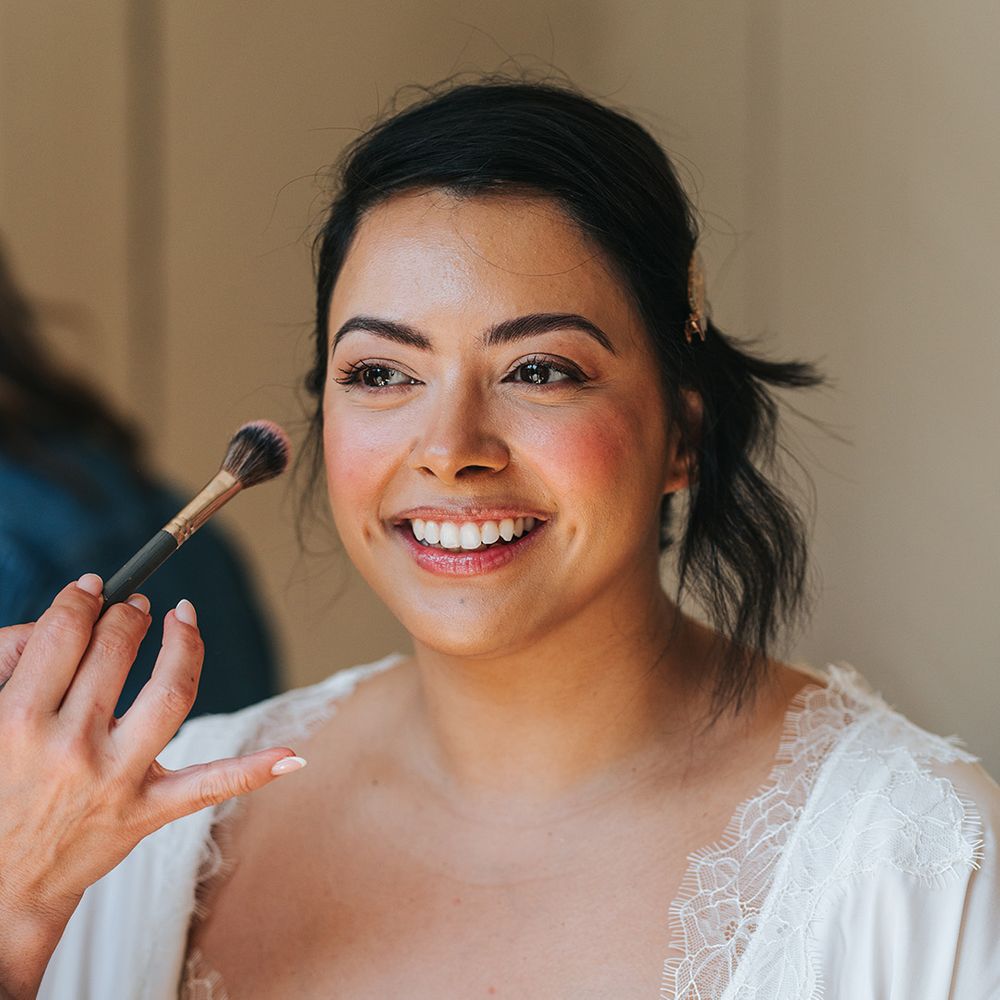bride-gets-makeup-done-for-wedding