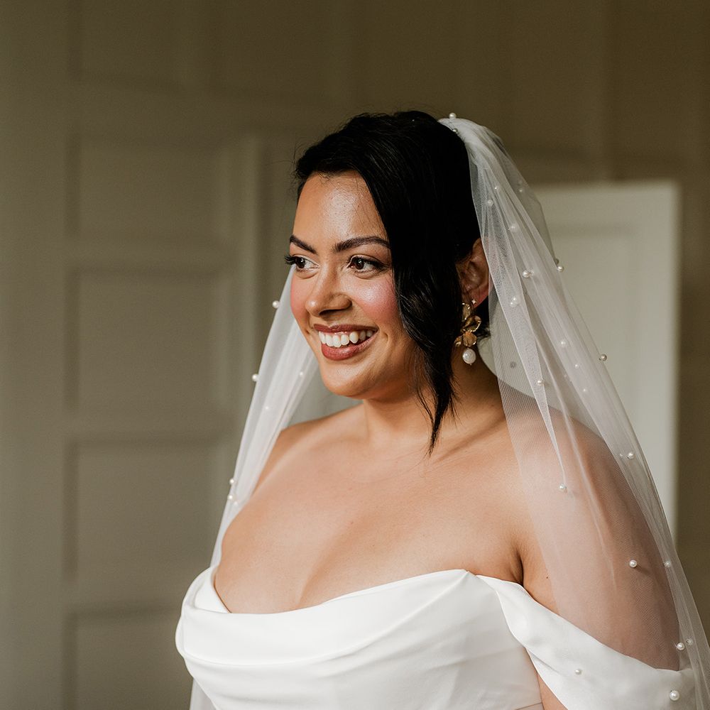 bride-in-off-the-shoulder-wedding-dress-with-pearl-wedding-veil