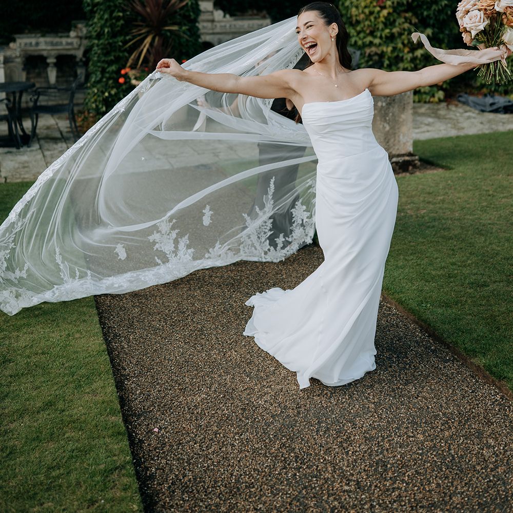 bride-in-strapless-wedding-dress-with-cathedral-length-veil