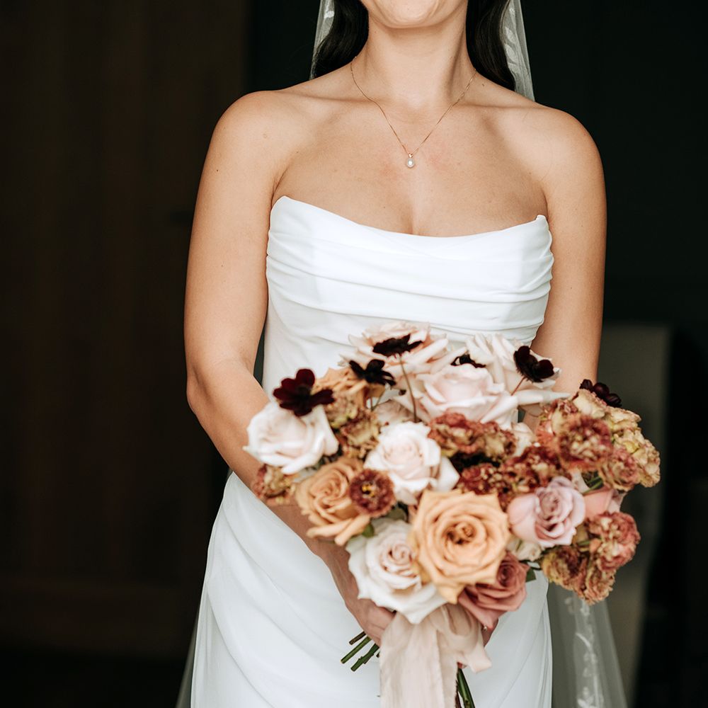 bride-in-strapless-wedding-dress-with-cream-wedding-bouquet