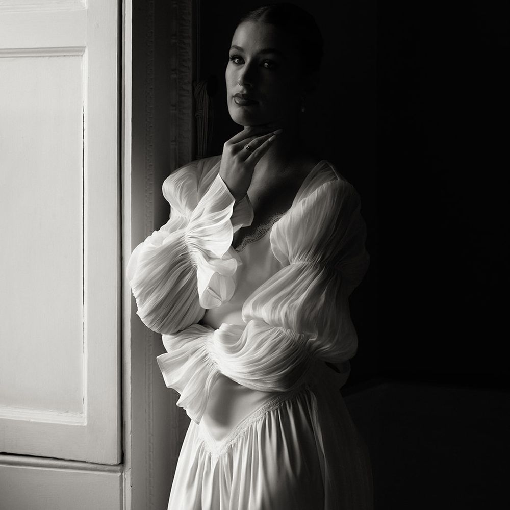 black-and-white-photo-of-bride-next-to-window