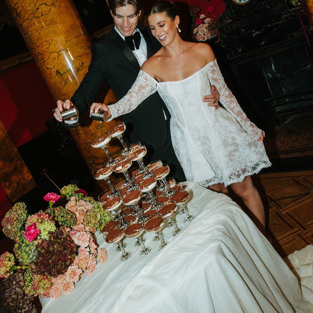 Bride in short lace wedding reception dress with groom for their dessert tower moment