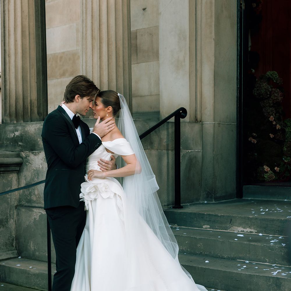 groom-embraces-bride-for-romantic-photo
