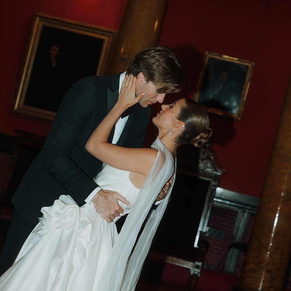 Groom embraces the bride at library wedding 