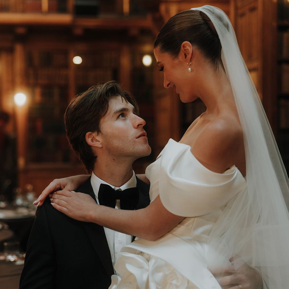 Groom looks up at bride at library wedding