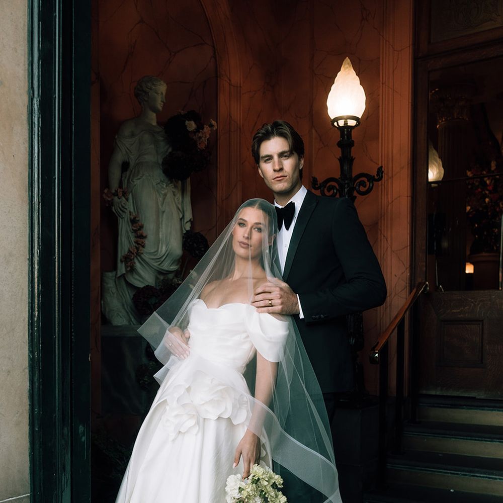 groom-rests-his-hands-on-brides-shoulders-for-couple-pose