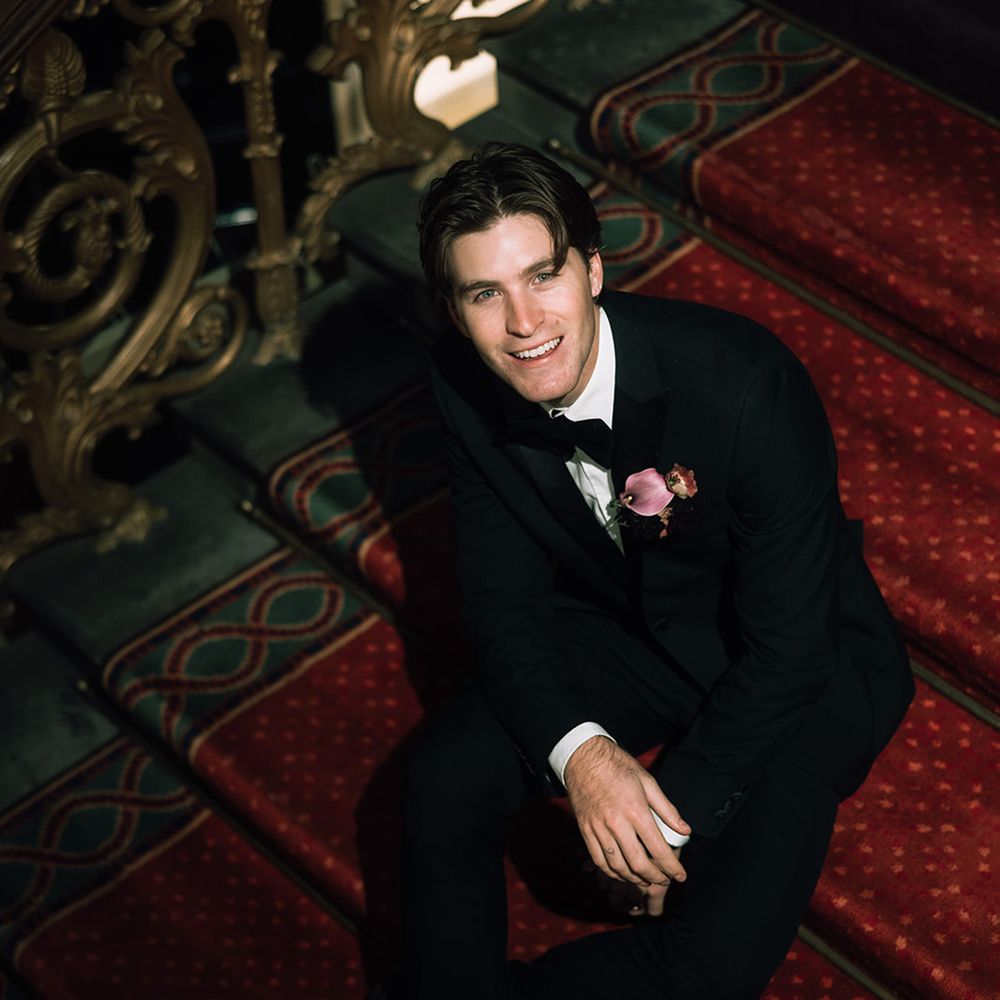 groom-smiling-sitting-on-staircase