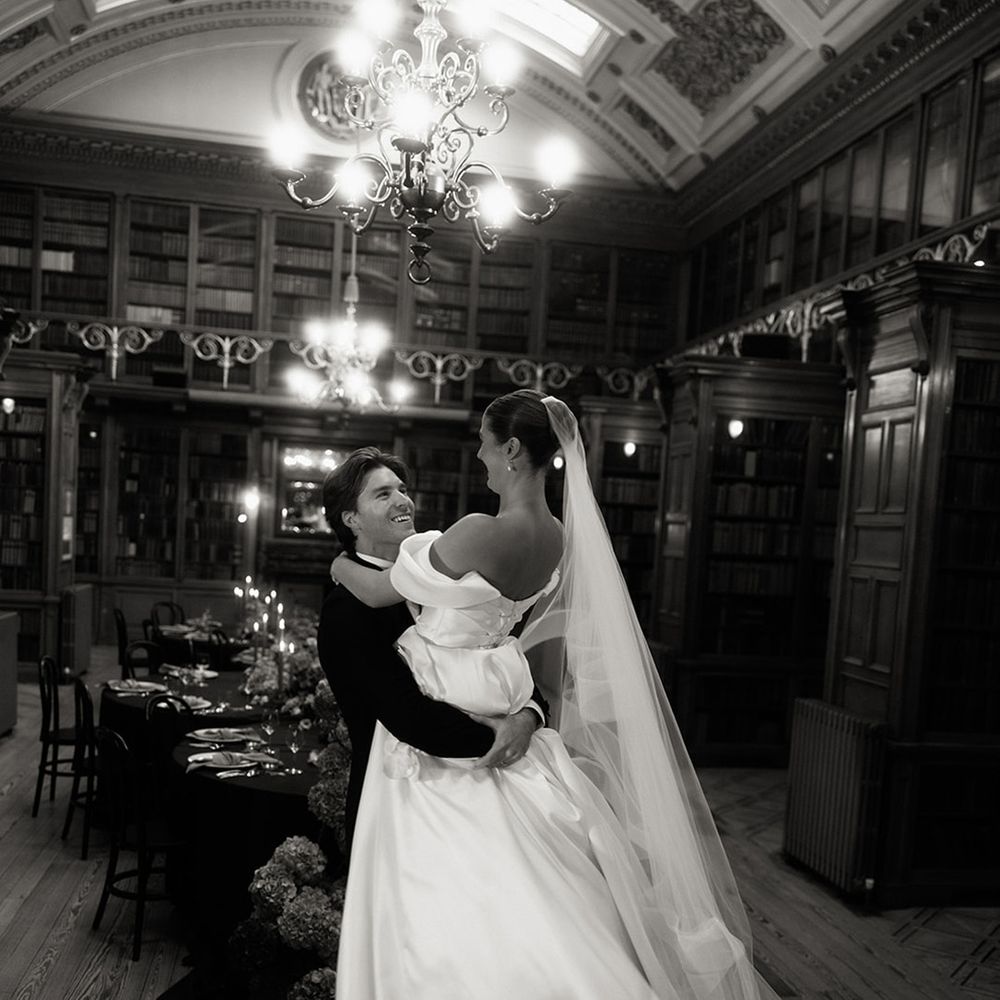 Groom spins the bride around in intimate first dance