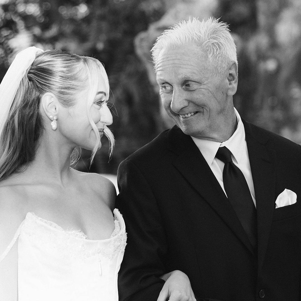 black-and-white-photo-of-father-of-the-bride-and-bride-sharing-a-look