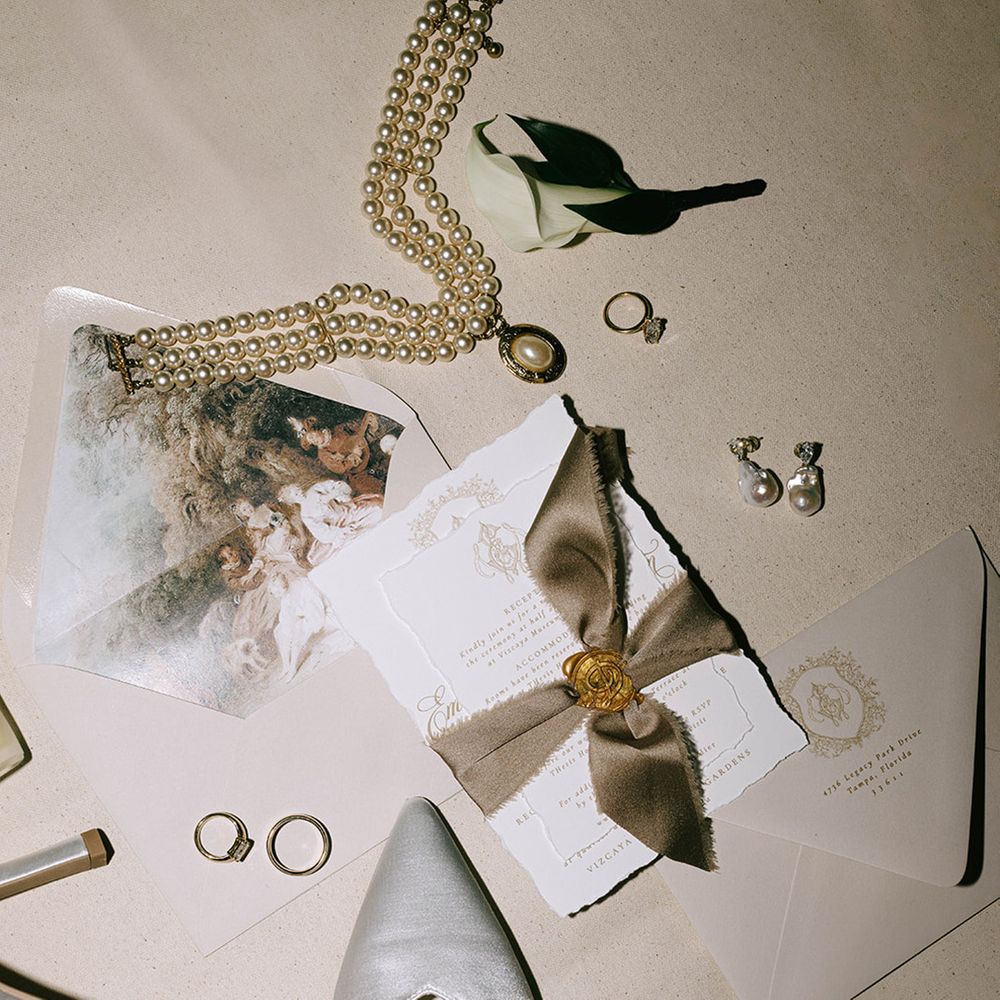 bridal-jewellery-and-shoes-with-wedding-stationery-tied-with-brown-ribbon