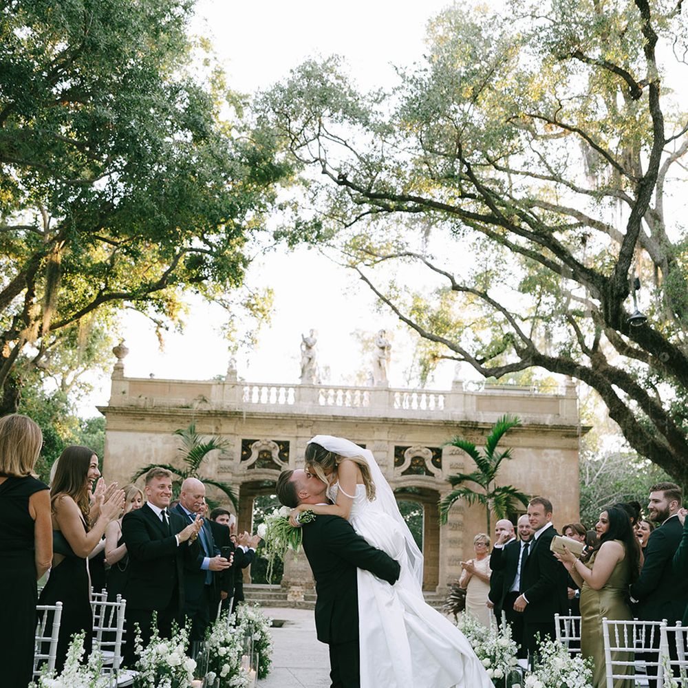 bride-and-groom-kiss-as-they-walk-back-down-the-aisle-as-a-married-couple