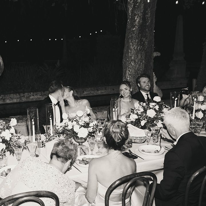 bride-and-groom-kiss-at-wedding-breakfast