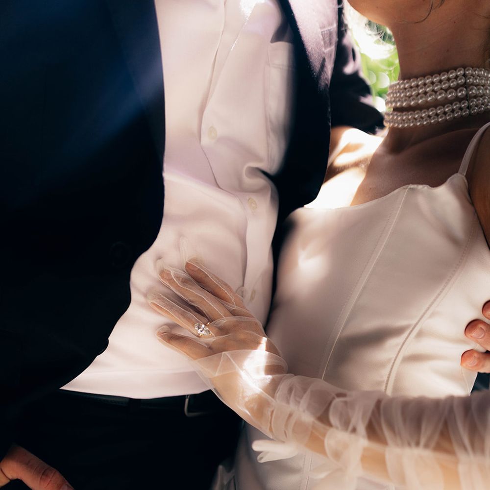 Marquise diamond engagement ring worn under sheer gloves