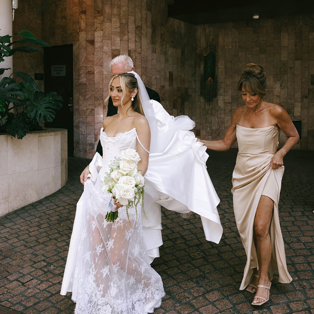 mother-and-father-of-the-bride-walks-bride-to-car