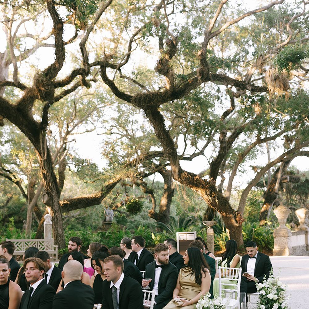 Wedding guests seated at the outdoor ceremony