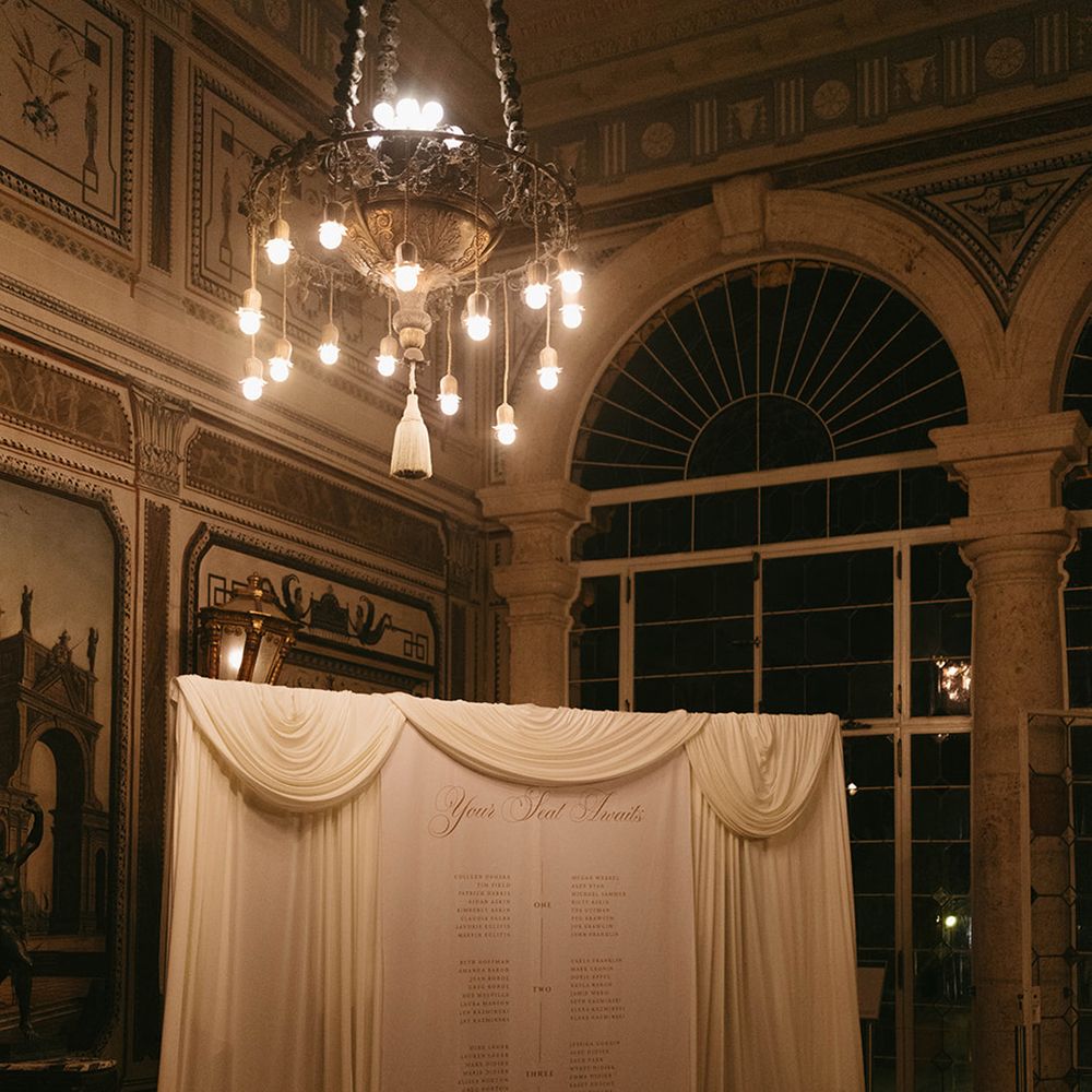 Luxe wedding seating chart signage with drapery