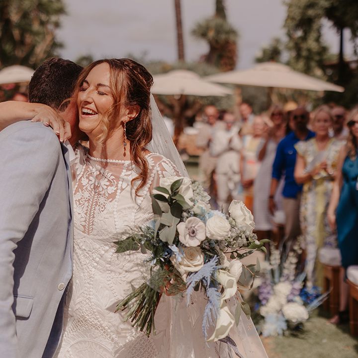 bride-and-grom-embrace-at-the-end-of-the-aisle