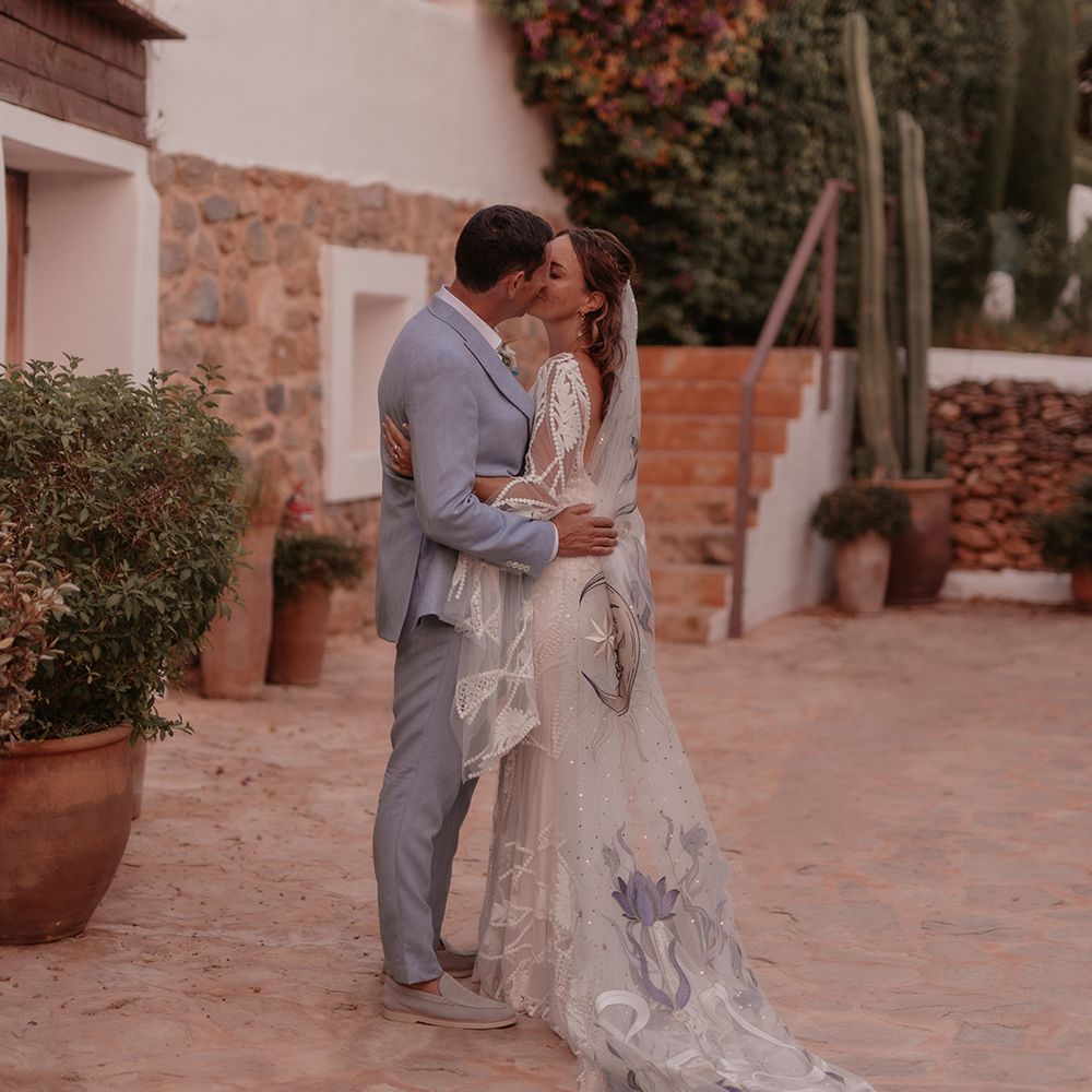 couple-kisses-wearing-blue-wedding-outfits