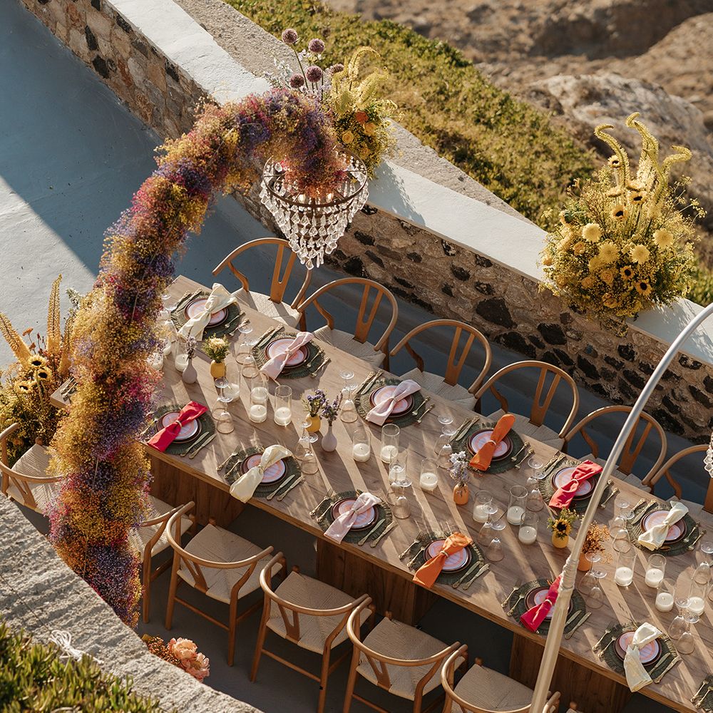 Gypsophila covered arms with chandeliers over intimate banquet tablescape 