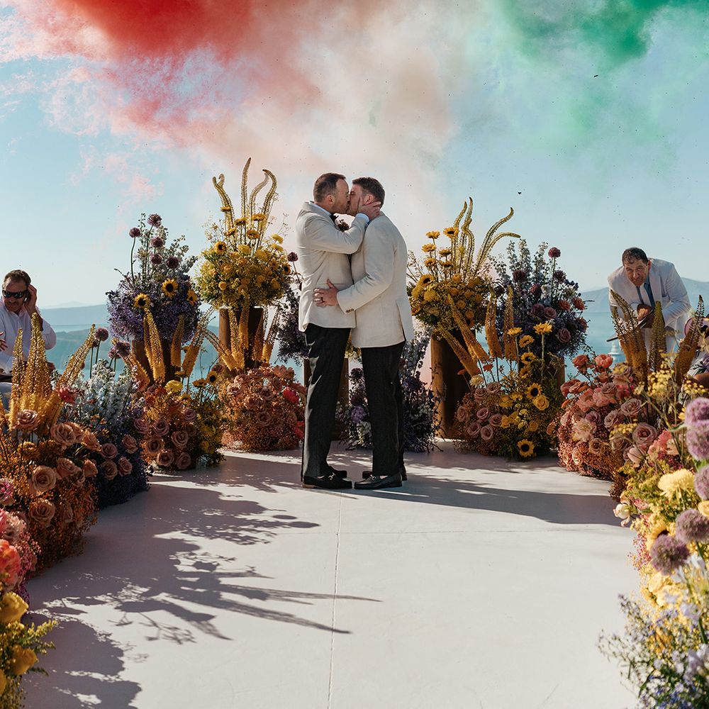 grooms-kissing-at-santorini-greece-wedding