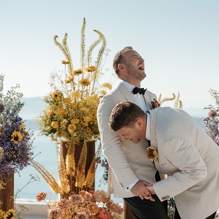 grooms-laughing-together-during-their-wedding-ceremony.