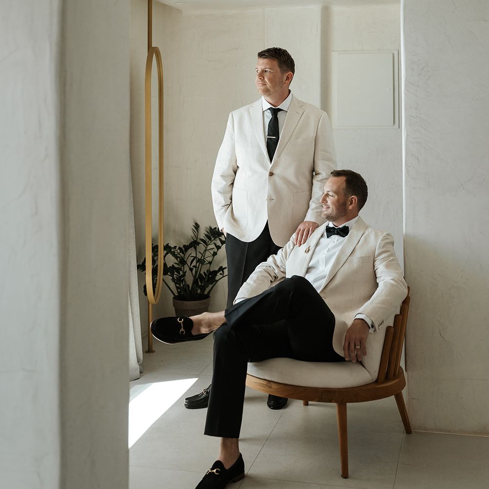 two-grooms-wearing-white-suits-with-black-bow-ties