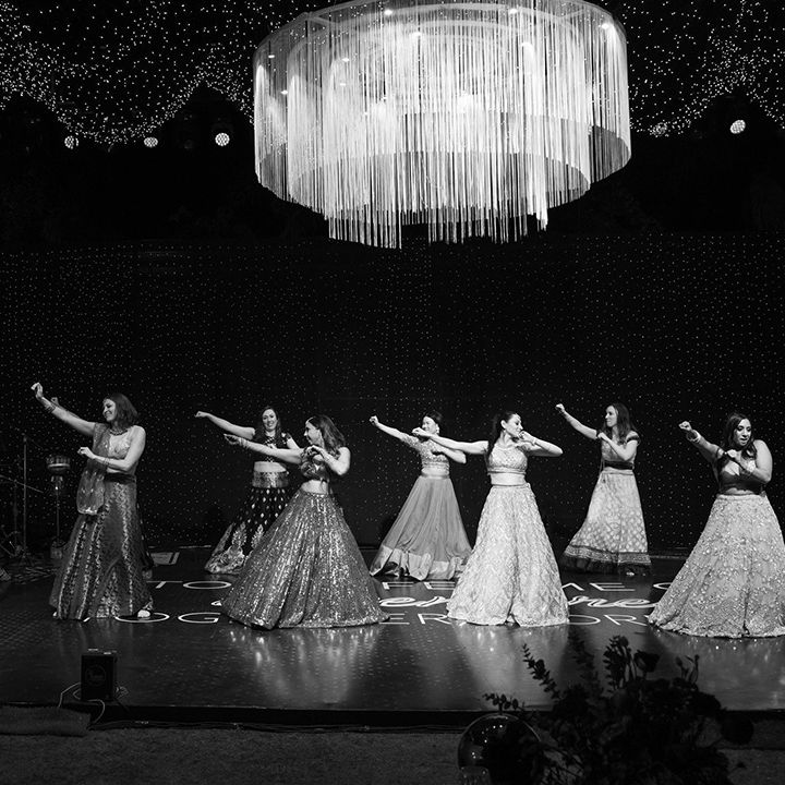 bride-and-bridesmaids-dancing-on-stage