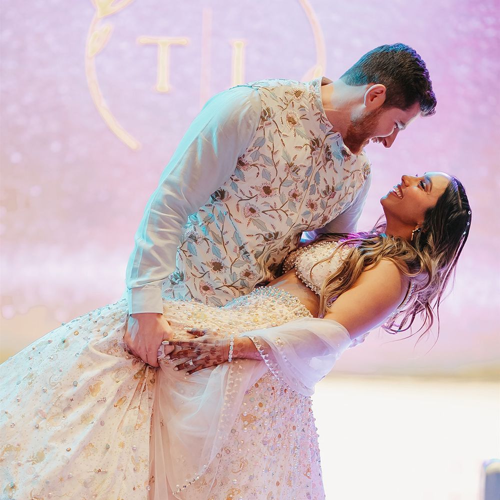 first-dance-moment-with-wedding-logo-backdrop