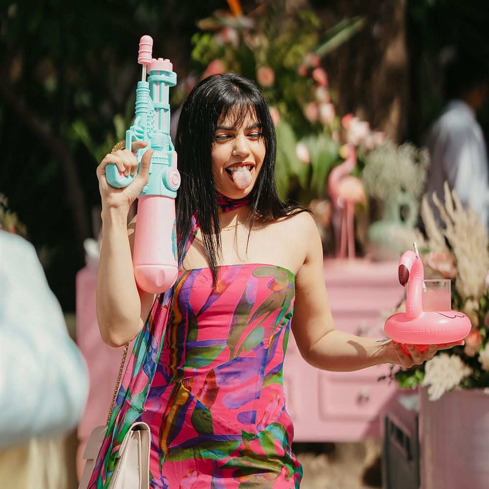 wedding-guest-with-water-gun-and-flamingo-drink-holder