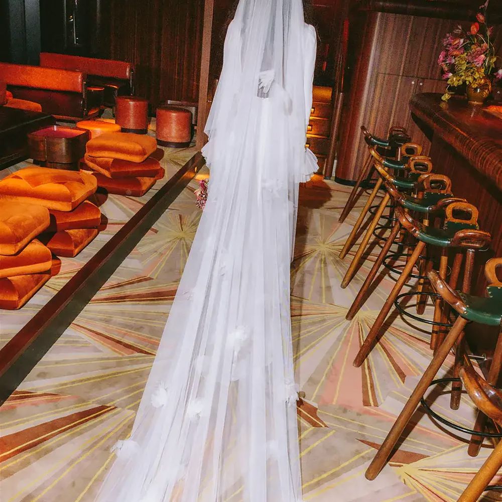 Bride wearing long veil with a train at The Standard Hotel