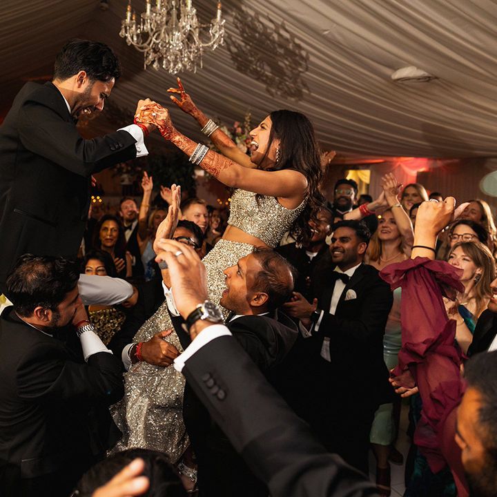 wedding-guests-lift-the-bride-and-groom-into-the-air