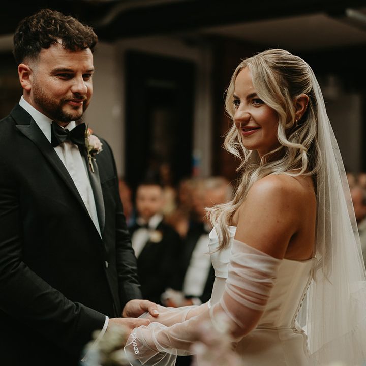 couple-holds-hands-for-their-wedding-ceremony