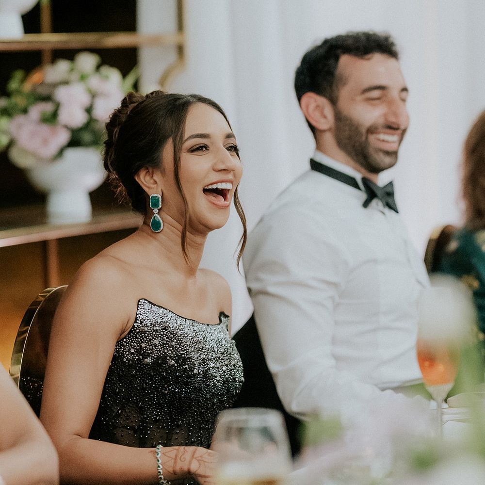 couple-laughs-during-wedding-speeches