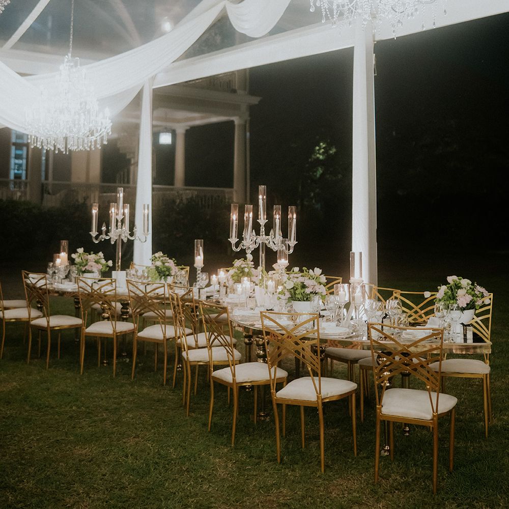 white-drapery-and-chandeliers-over-banquet-table