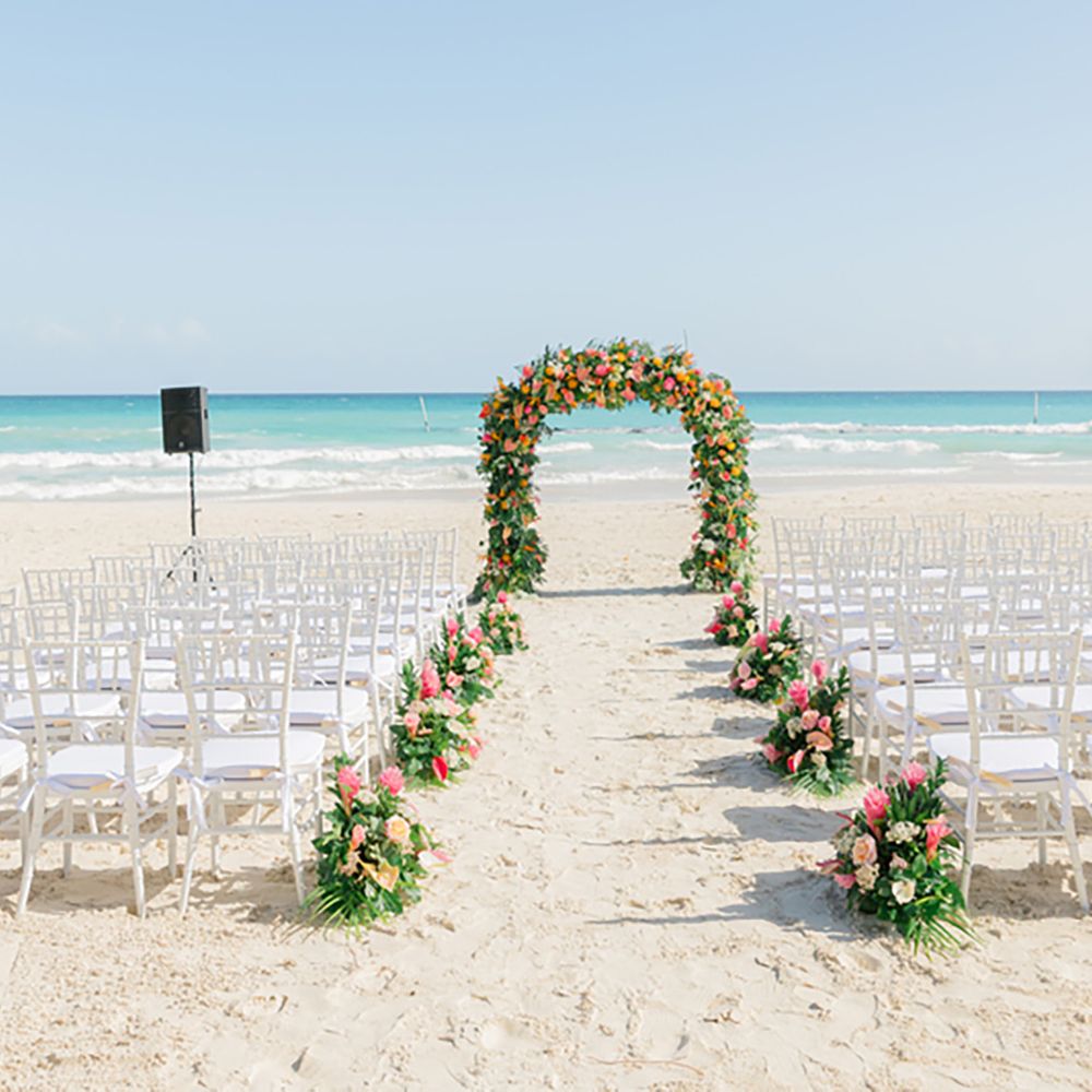 Sandals Resorts Caribbean destination wedding beach ceremony with floral arch 