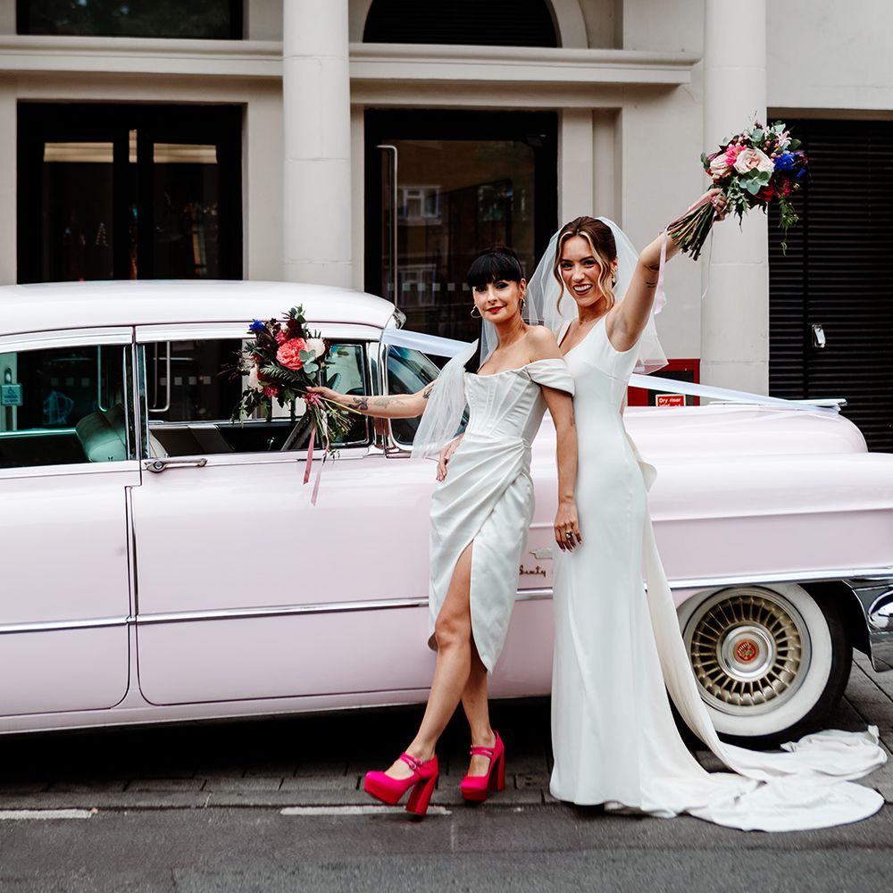 brides-in-front-of-light-pink-wedding-car